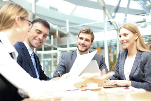 Group of business partners discussing ideas and planning work in office