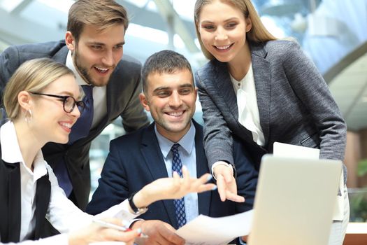 business team working on laptop to check the results of their work