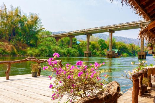 Concept of travel, family tourism. View of the bridge from the floating tourist hut on the river Kwai. Thailand.