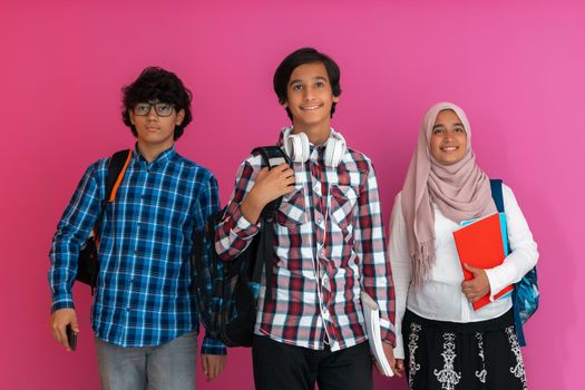 A group of Arab teenagers, a student team walking forward into the future and back to school the concept of a pink background. The concept of successful education for young people. Selective focus. High quality photo