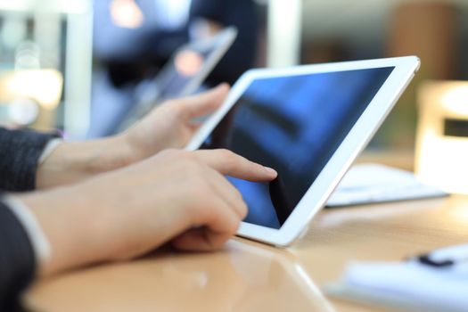 Image of human hand pointing at touchscreen in working environment at meeting