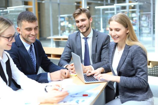 Group of business partners discussing ideas and planning work in office