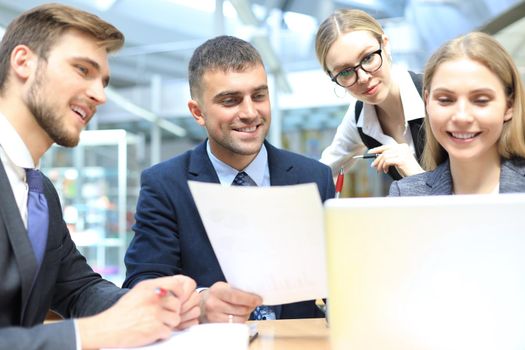 Image of business partners discussing documents and ideas at meeting