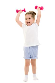 A cute little girl doing exercises with dumbbells. The concept of strength, health and sport. Isolated on white background.