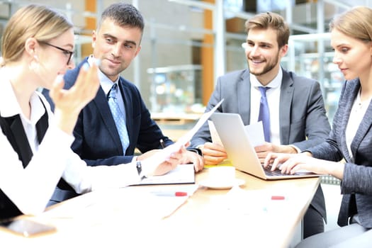 Group of business partners discussing ideas and planning work in office