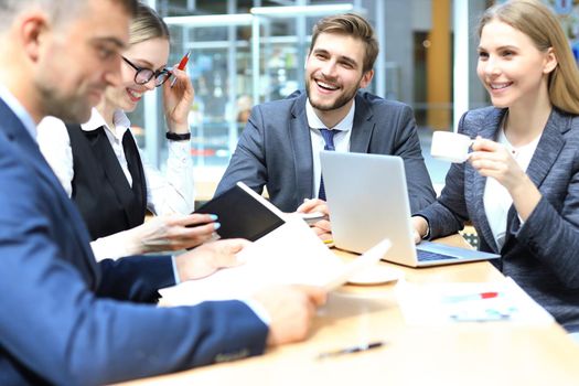 Group of business partners discussing ideas and planning work in office