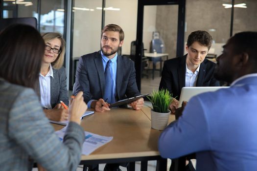 Business meeting - manager discussing work with his colleagues