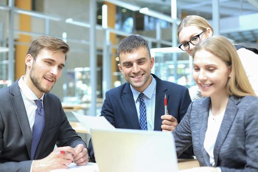 Image of business partners discussing documents and ideas at meeting