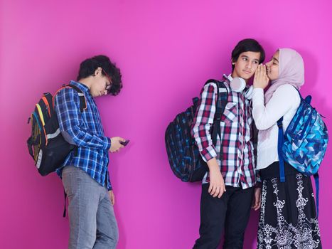 teens make fun of a mixed race teen outdoors on a picnic bench