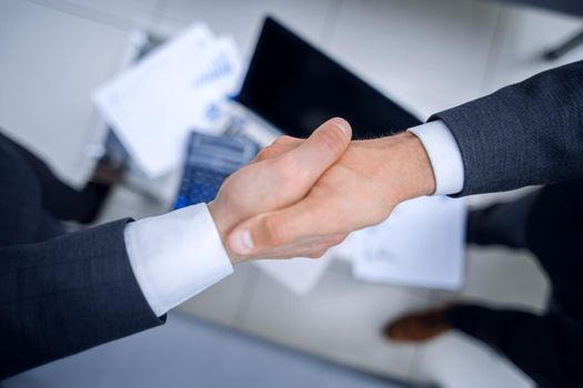 close up.business handshake over blurry background.business concept