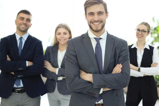 Businessman with colleagues in the background in office