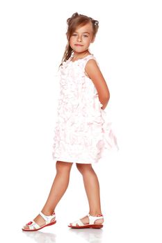 Fashionable little girl in a dress. Beauty and style in children's clothes. Isolated over white background