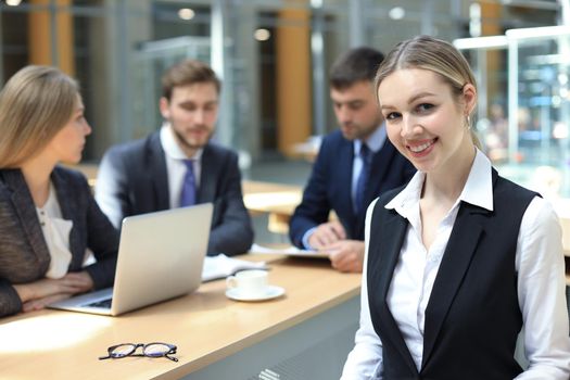 business woman with her staff, people group in background at modern bright office indoors