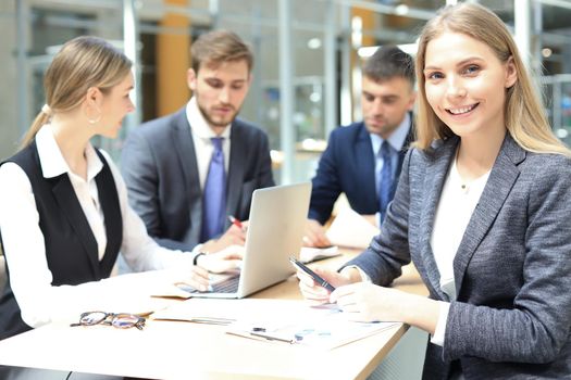 business woman with her staff, people group in background at modern bright office indoors