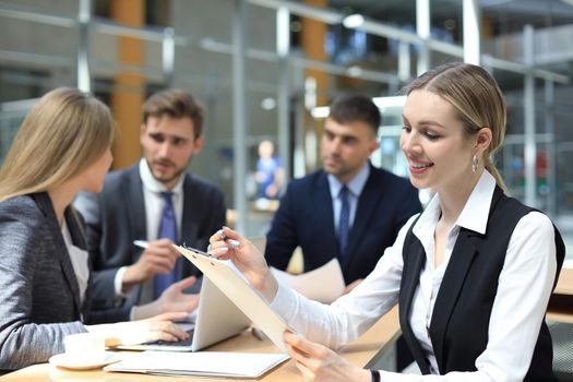 business woman with her staff, people group in background at modern bright office indoors