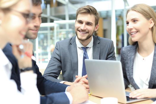 Group of business partners discussing ideas and planning work in office