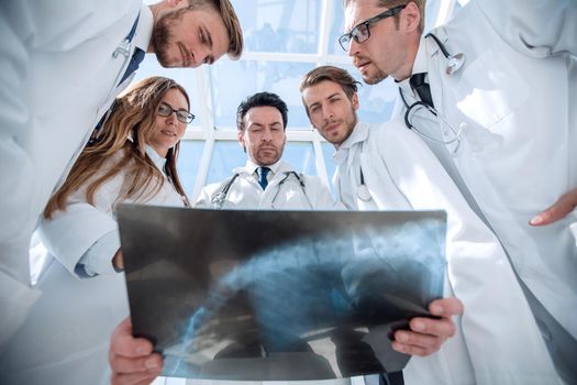 doctors colleagues look at the x-ray of the patient . the concept of teamwork