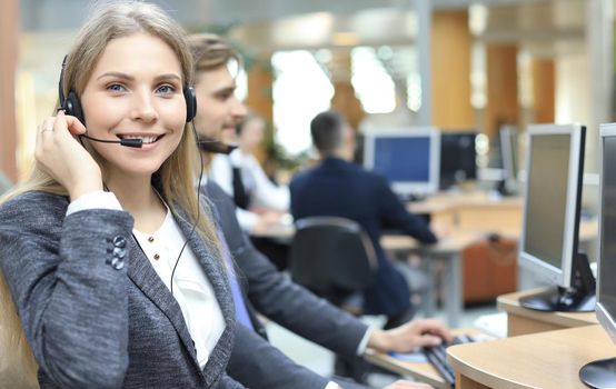 Female customer support operator with headset and smiling