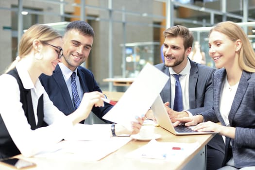 Group of business partners discussing ideas and planning work in office