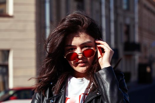 young pretty asian girl wearing sunglasses outside on big city street, lifestyle people concept close up