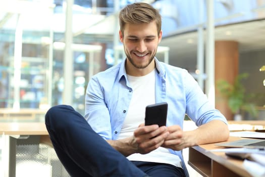 Businessman using his mobile phone in the office