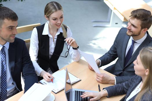 Image of business partners discussing documents and ideas at meeting