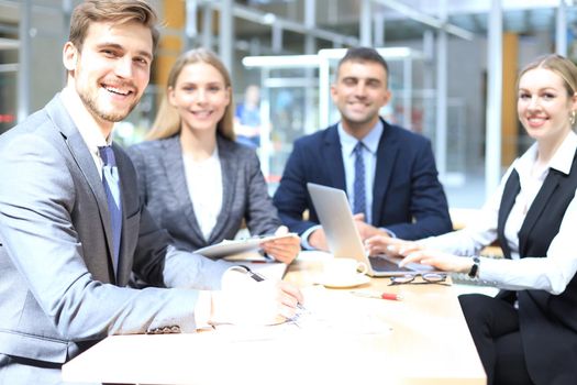 Businessman with colleagues in the background in office