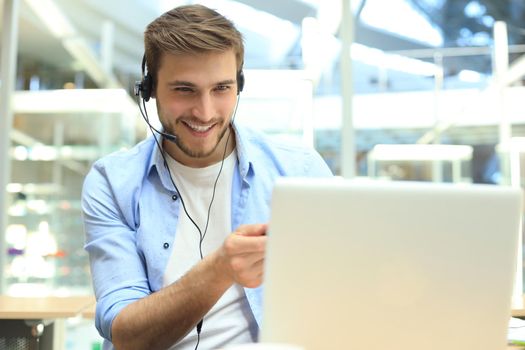 Smiling friendly handsome young male call centre operator