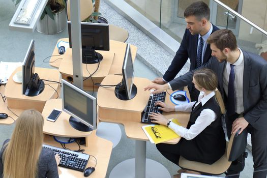 Top view of buiness team brainstorming while sitting at the office table together