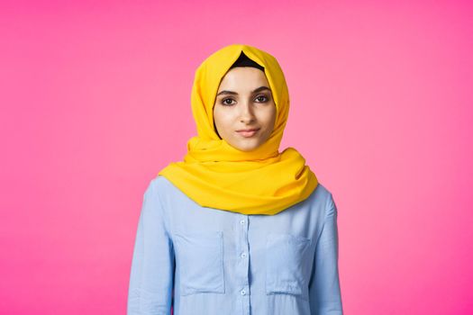 muslim woman in hijab posing fashion ethnicity pink background. High quality photo