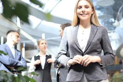 Face of beautiful woman on the background of business people