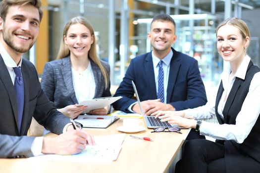 Businessman with colleagues in the background in office