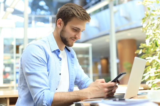Businessman using his mobile phone in the office