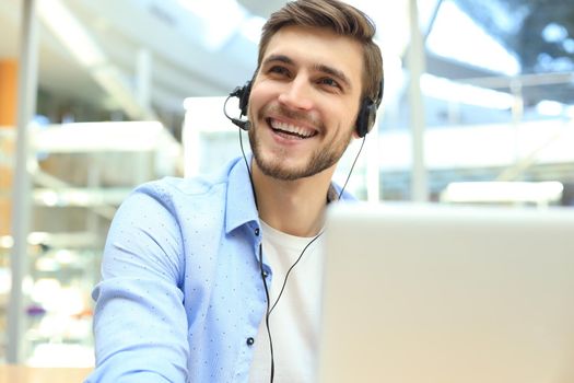 Smiling friendly handsome young male call centre operator