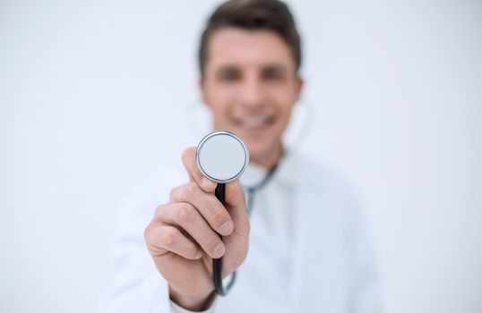 smiling doctor showing stethoscope.the concept of diagnosis