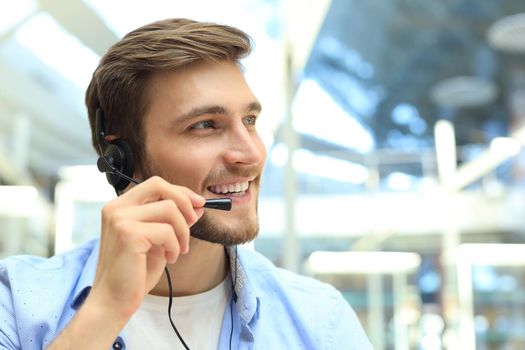 Smiling friendly handsome young male call centre operator