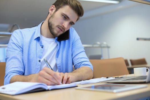 Businessman using his mobile phone in the office