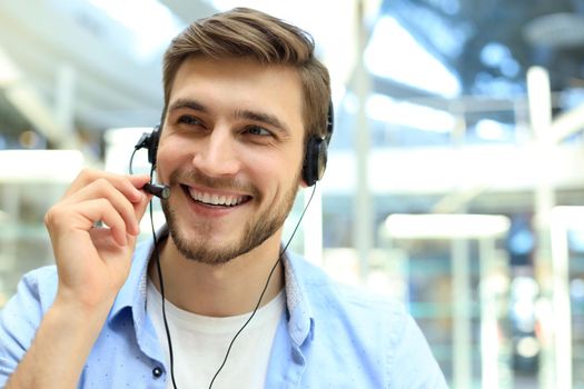 Smiling friendly handsome young male call centre operator