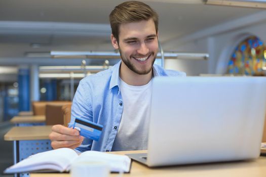 Portrait of young man sitting at his desk in the office