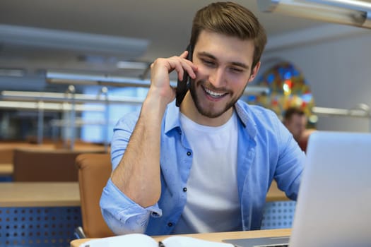Businessman using his mobile phone in the office