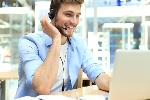 Smiling friendly handsome young male call centre operator