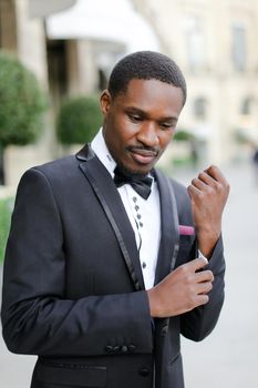 Afro american good looking man wearing suit and smiling. Concept of black businessman.