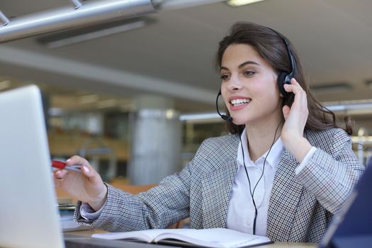 Woman customer support operator with headset and smiling