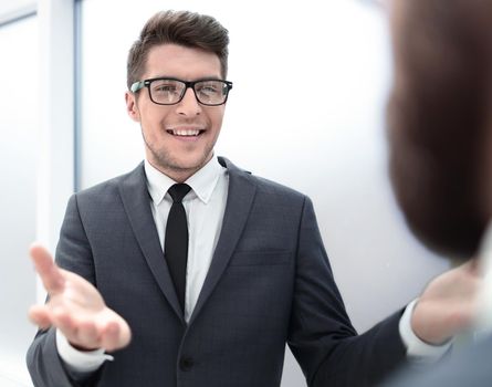 young businessman talking standing in the office.business concept