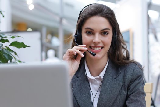 Female customer support operator with headset and smiling