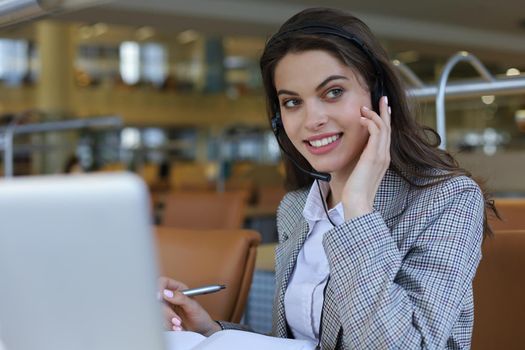 Woman customer support operator with headset and smiling