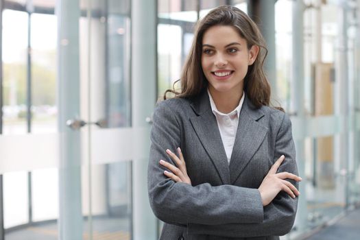 Attractive businesswoman standing near desk in the office