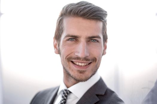 close up.portrait of a young businessman on a blurred background.