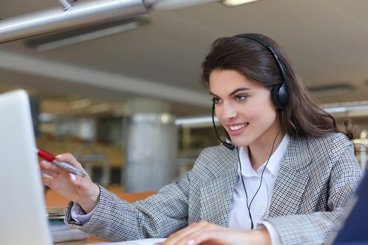 Woman customer support operator with headset and smiling