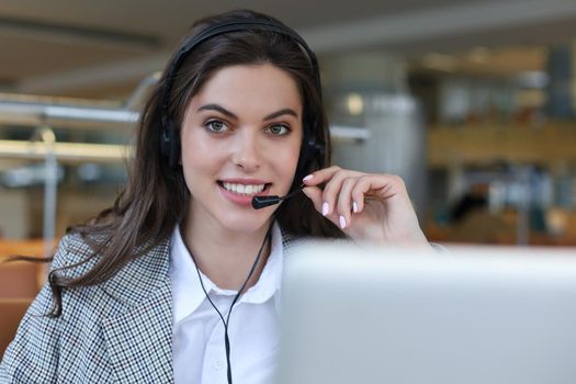 Female customer support operator with headset and smiling